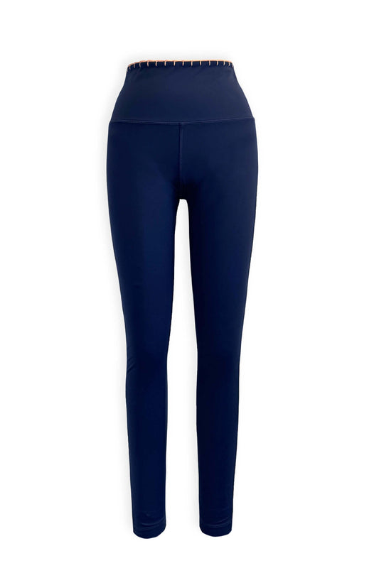 These high waist compression leggings have moisture wicking sustainable fabric in our favorite shade of Navy. Featuring hand crocheted scalloped edges in the perfect peach.&nbsp; Side pockets to store the essentials.