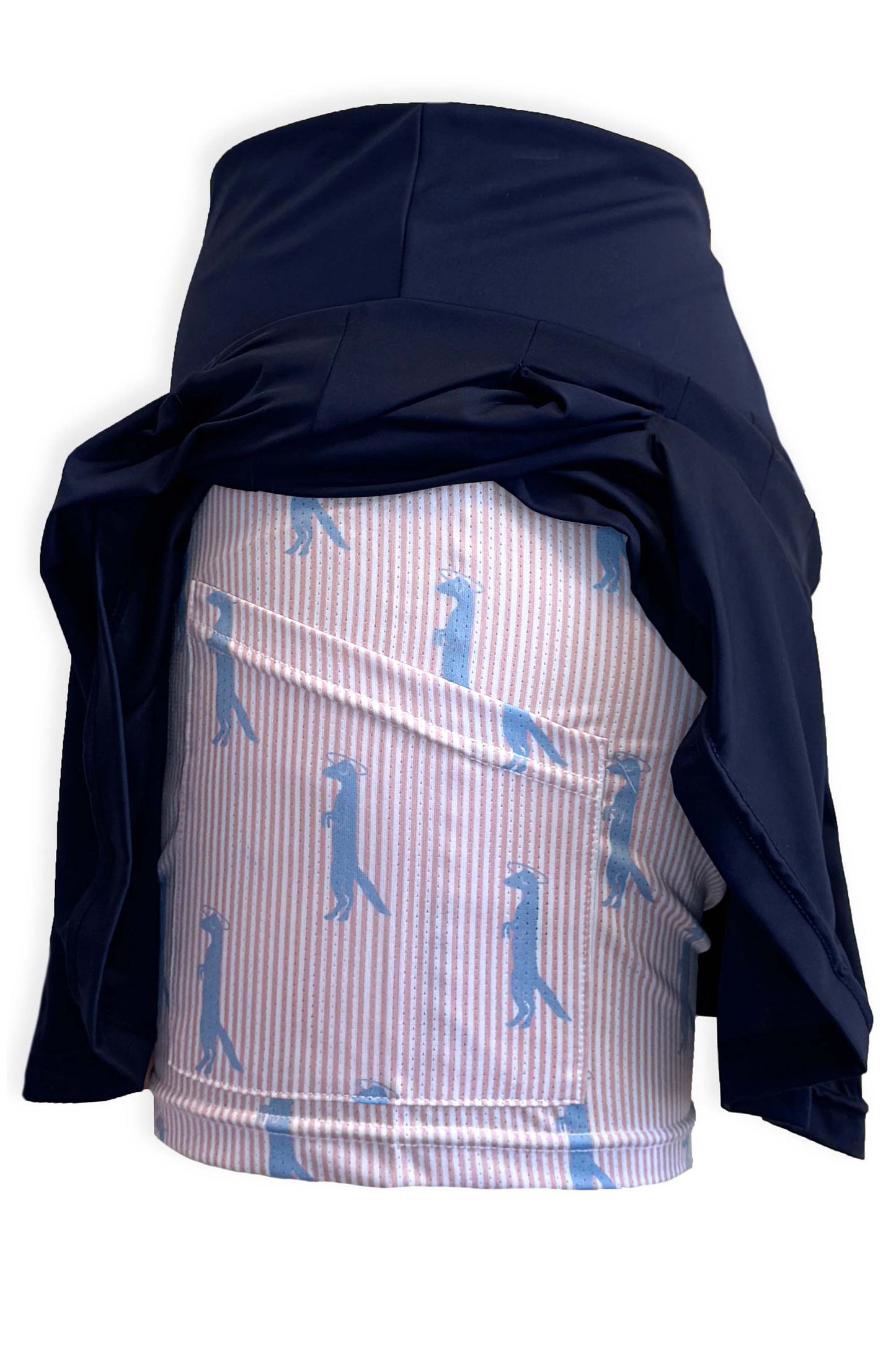 Navy pleated tennis skirt in soft, stretchy and sustainable fabric. Built in shorts with pockets in peach and white seersucker fabric with the brand's Mongoose logo.